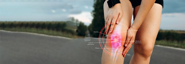 A person holding their knee in pain.